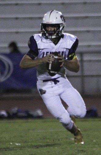 Tiger quarterback Logan Ahlin has his eyes on another TD pass. He had three against Hanford West.